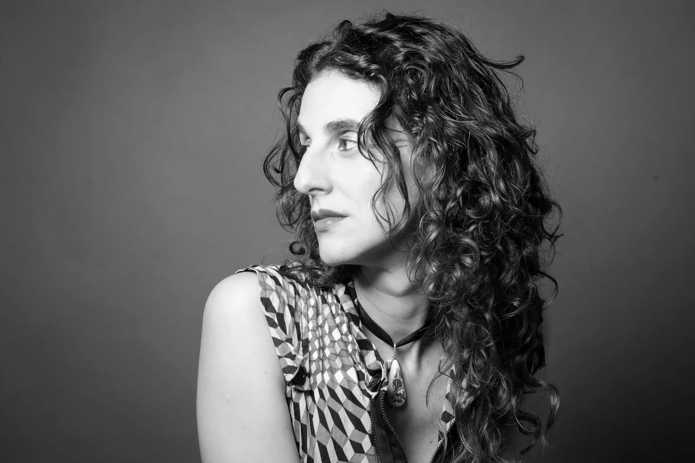 Vanessa Rosa looking over her shoulder, in black and white.