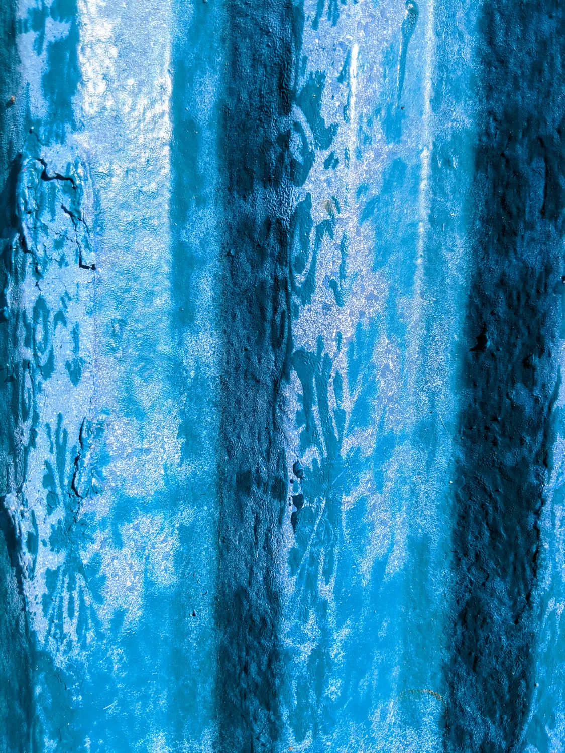 The blue gone chalky, the stencil still legible.