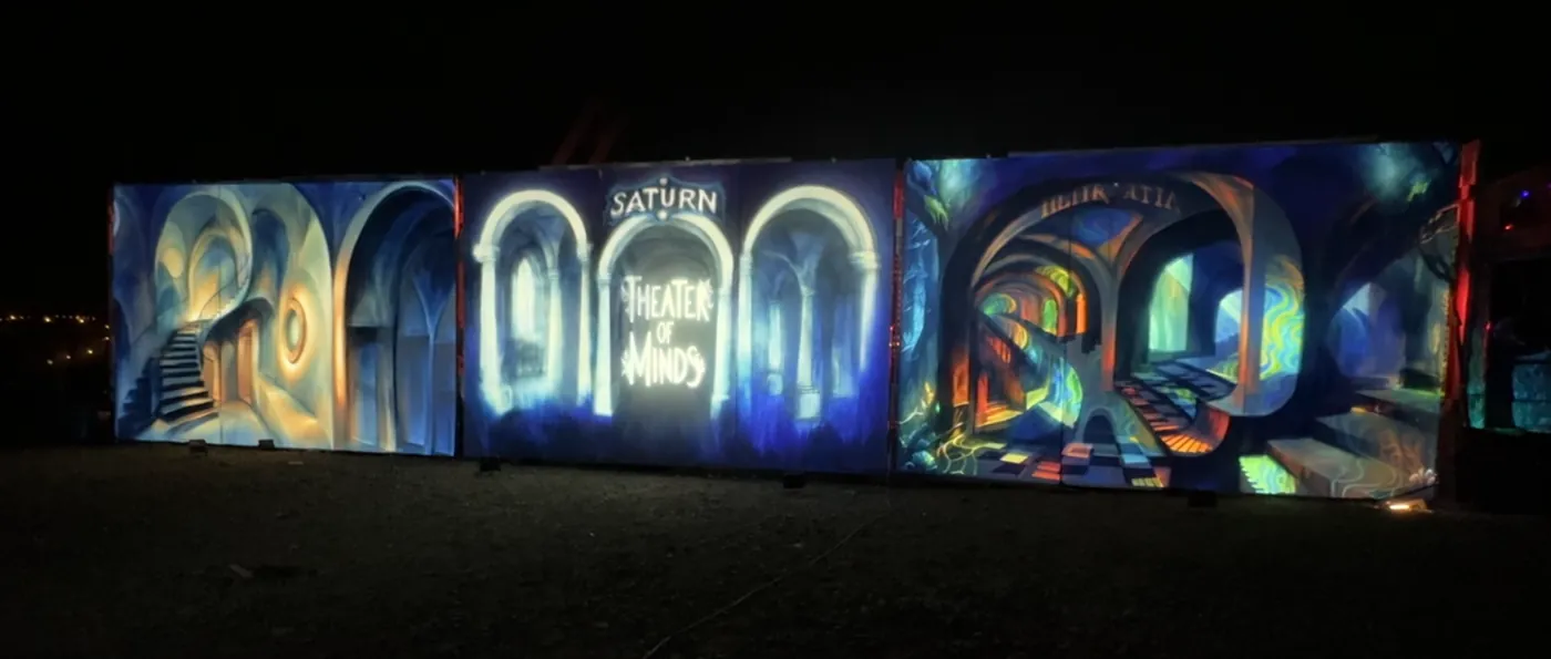 A three-channel projection-mapped installation inside a painted theatre.