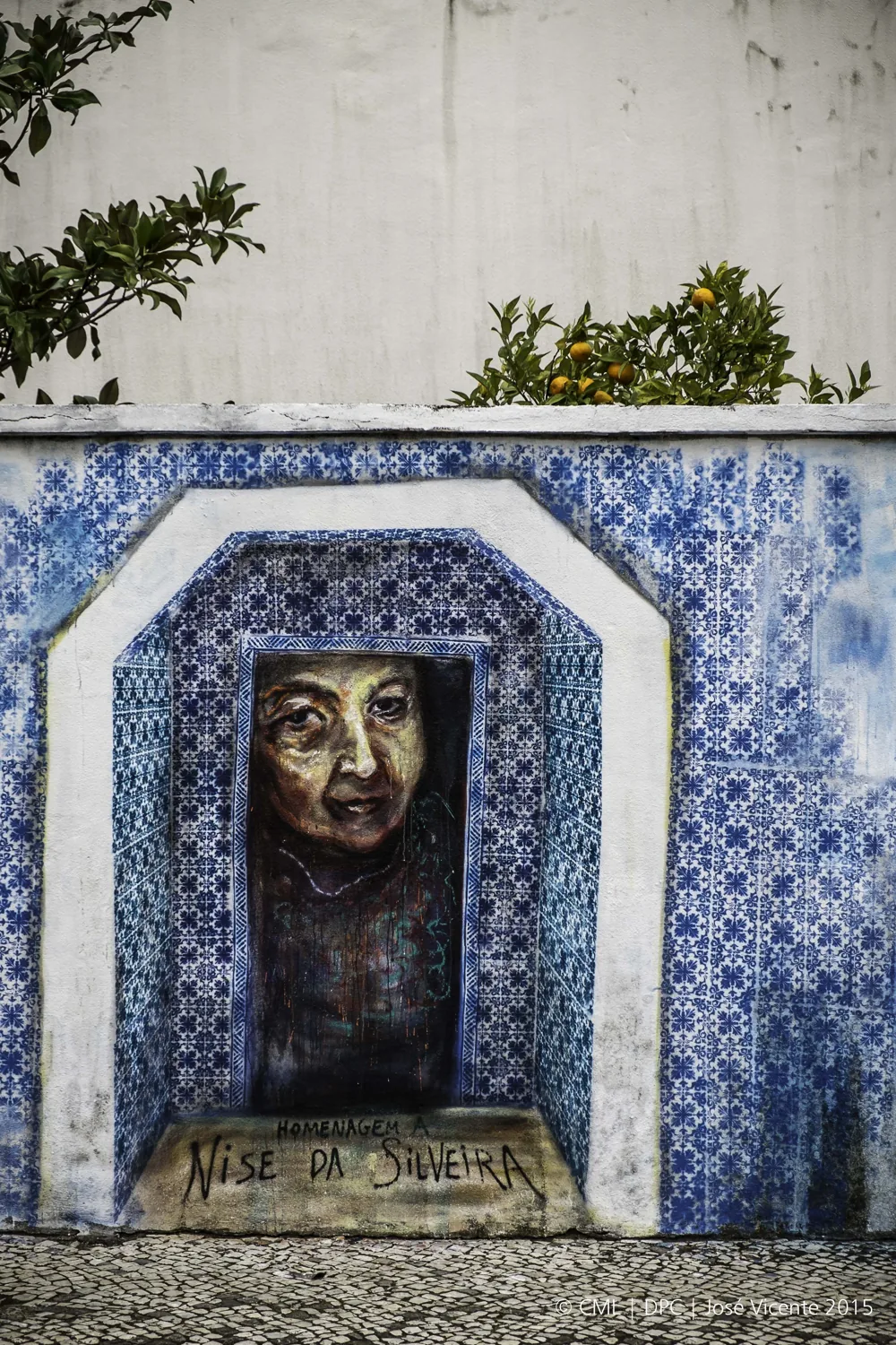 A blue-and-white tiled wall painted with laser-cut stencils, Lisbon.