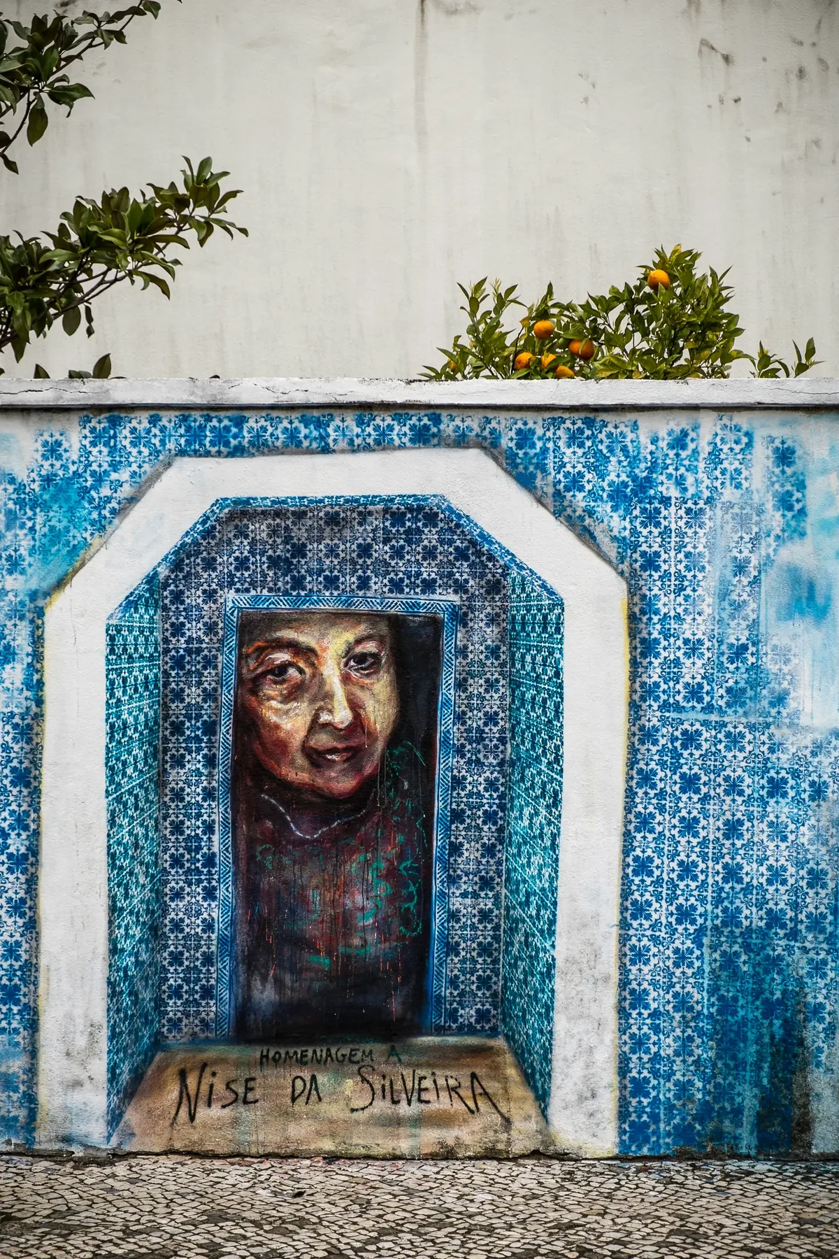 A blue-and-white tiled wall painted with laser-cut stencils, Lisbon.