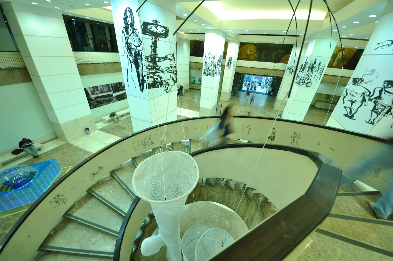 The anamorphic landscape wrapped around the columns at Caixa Cultural.