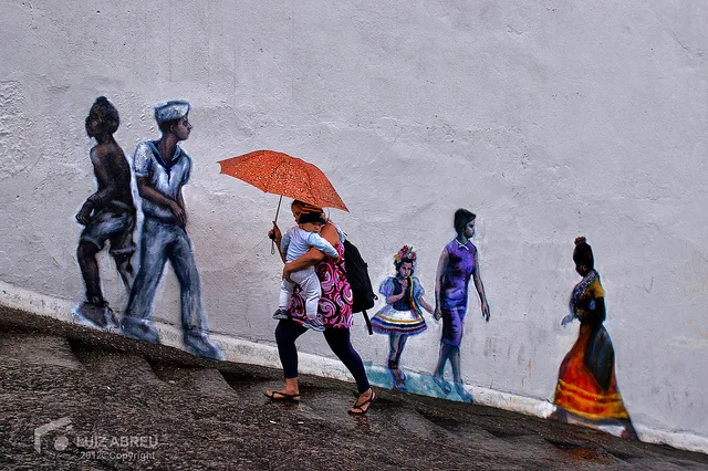 Life-size painted figures on a wall in Rio’s port zone.