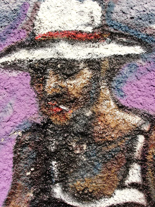 A painted figure in a hat