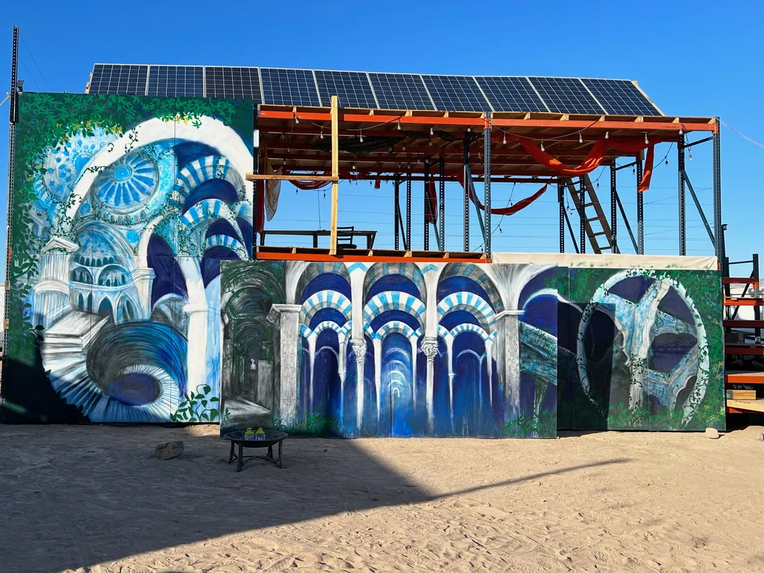 Painted blue archways on a solar-powered structure at Mars College, in the desert.